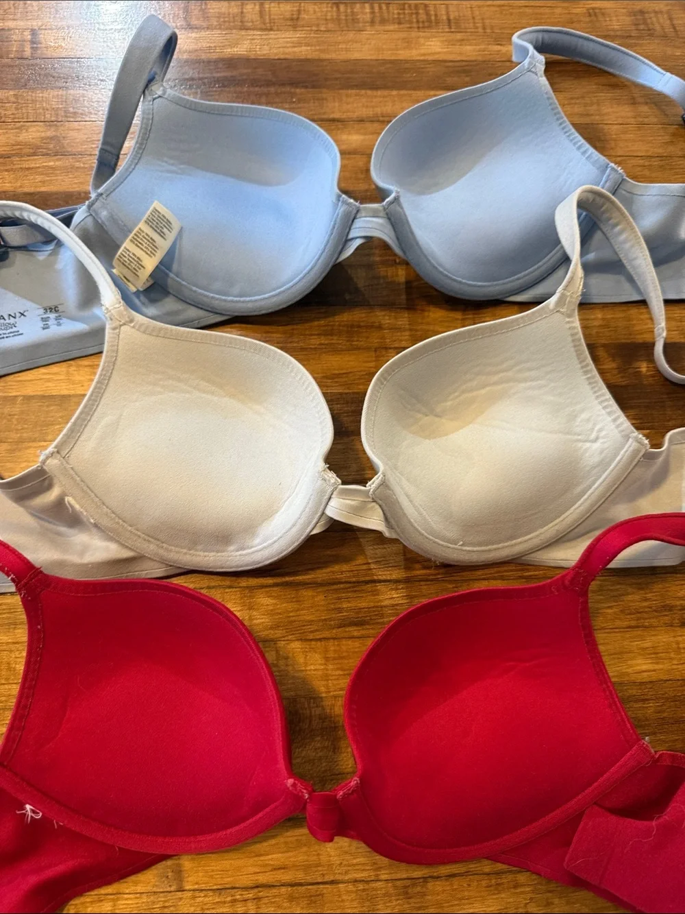 Three-pack SPANX Smooth T-Shirt Bras in Light Blue, Cream, and Red